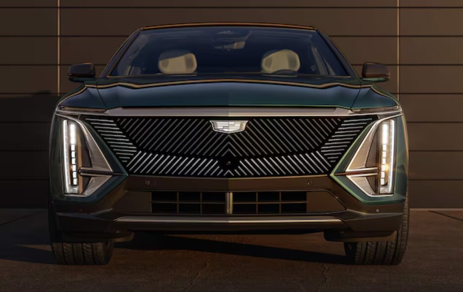 Service Your Electric Vehicle At Cadillac of Birmingham's Service Center Head-on view of a Cadillac EV parked in front of a garage