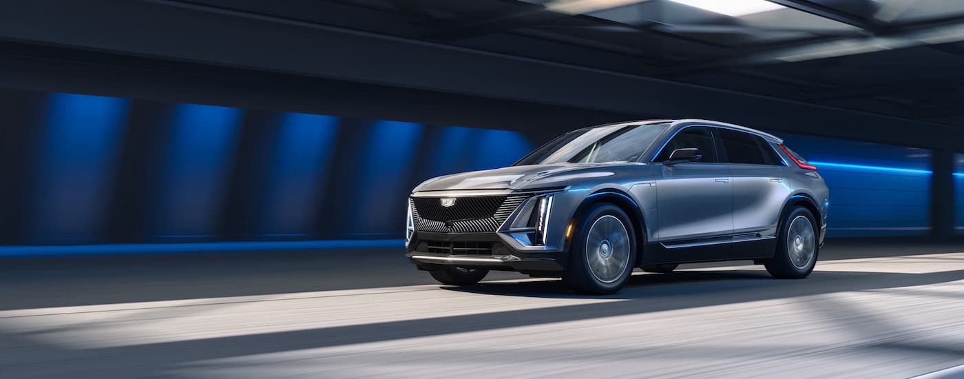A silver 2024 Cadillac Lyriq is shown from the front at an angle after leaving a dealer that has a Cadillac Lyriq for sale.