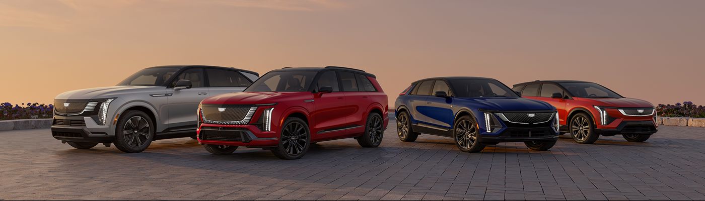 Cadillac SUV Lineup Cadillac SUVs parked in a line at dusk