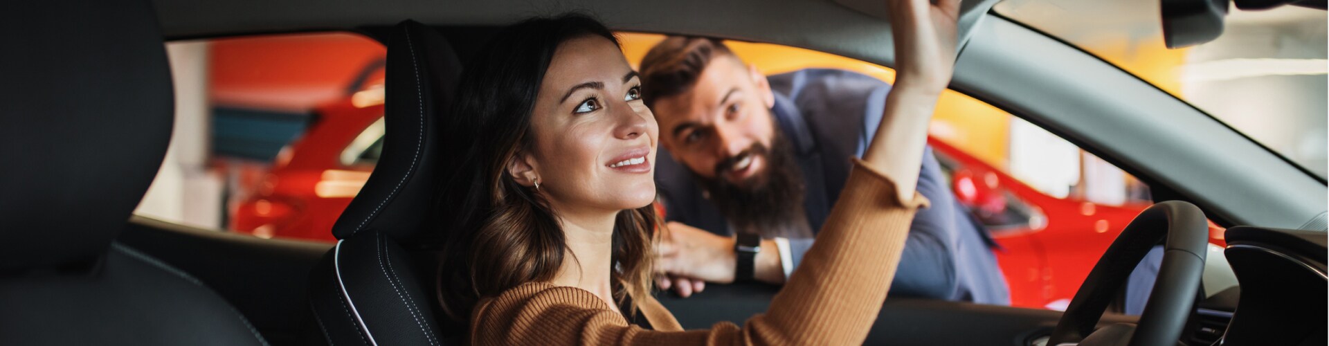 Woman checking rear view mirror before driving off