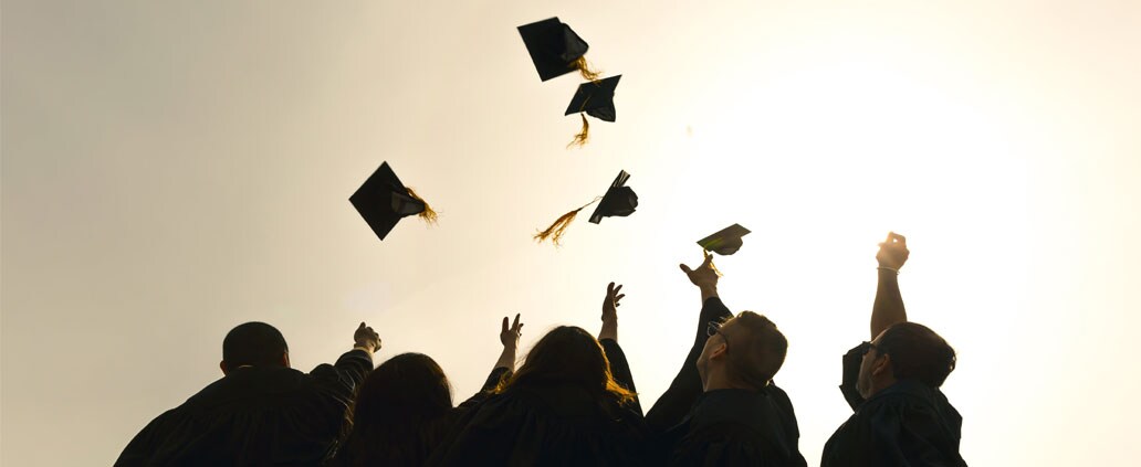 College Graduates Throwing Graduation Caps