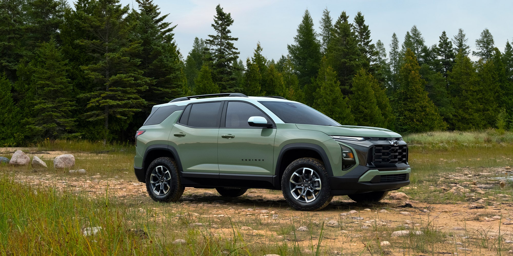 A green Chevrolet Equinox in a forest clearing A green Chevrolet Equinox in a forest clearing
