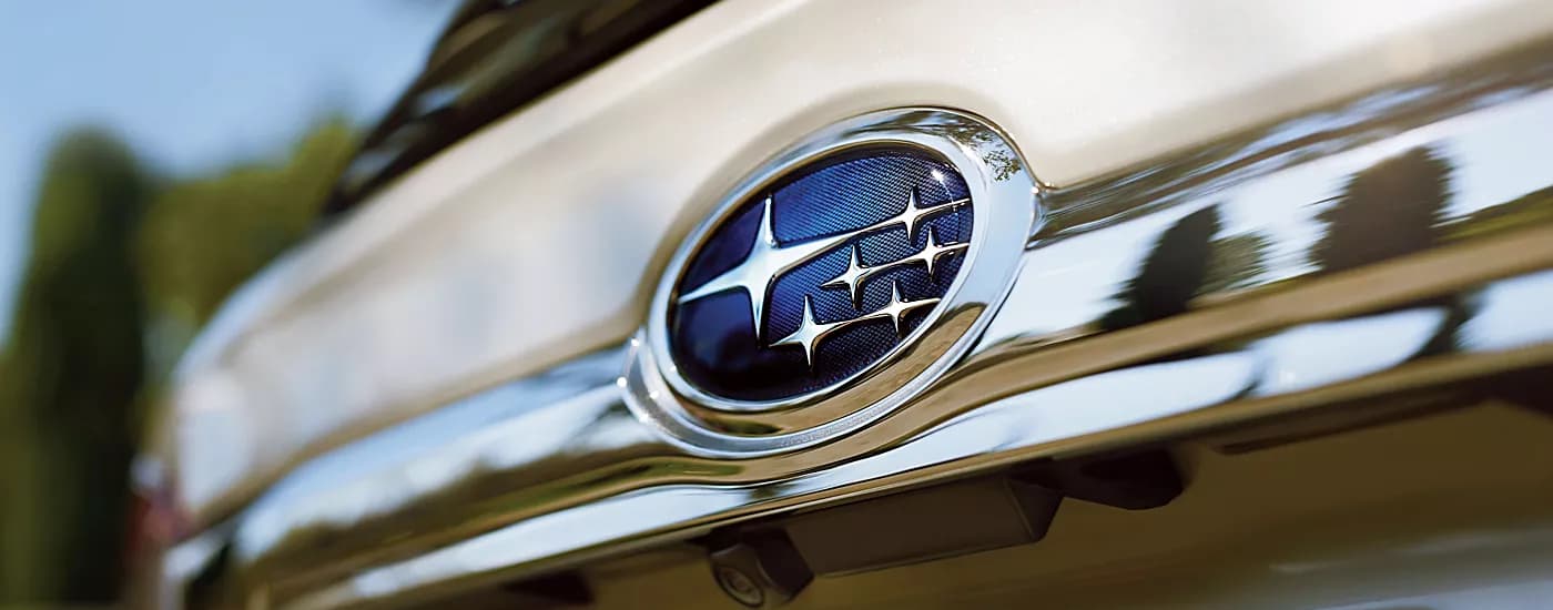 Used Subaru Outback - Subaru Badge - Stars.jpg A close up shows the Subaru badge on a white used Subaru Outback.