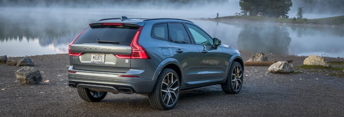 Grey Volvo XC60 back passenger view by lake