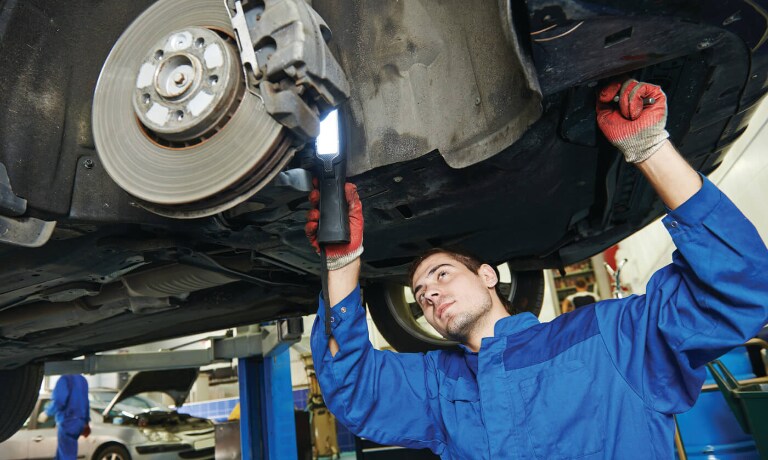 Technician checking brakes