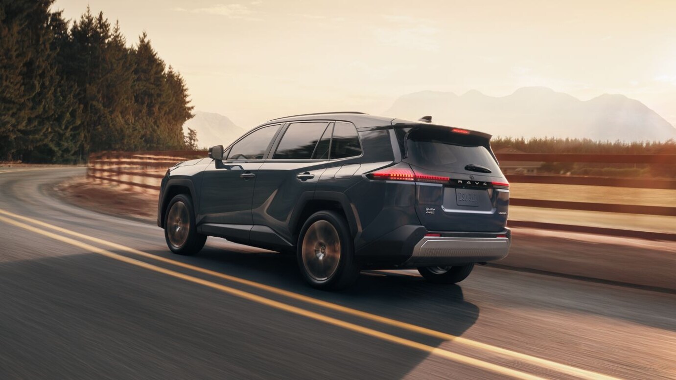 Smiling family looking inside of their used vehicle