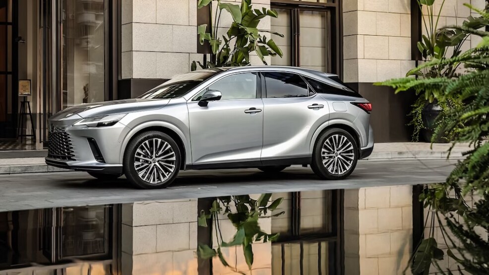 A silver Lexus RX SUV parked beside a reflecting pool