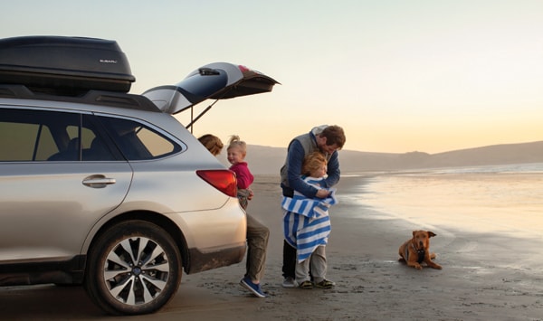 Subaru family at the beach with their dog.jpg