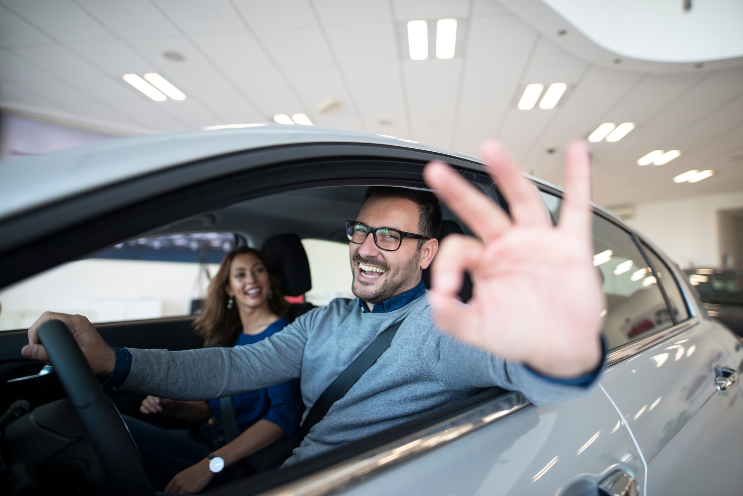happy-customer-buying-new-car-dealership.jpg