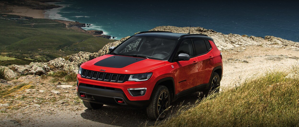 2020 Jeep Compass In Orange Parked In Front of The Ocean 2020 Jeep Compass In Orange Parked In Front of The Ocean