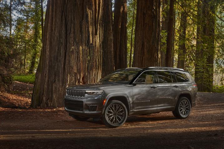Vue latérale du Jeep Grand Cherokee 2021 stationné sur un sentier en forêt