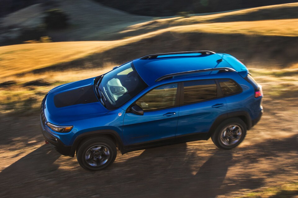 Blue Jeep Cherokee Trailhawk Driving In Desert Blue Jeep Cherokee Trailhawk Driving In Desert