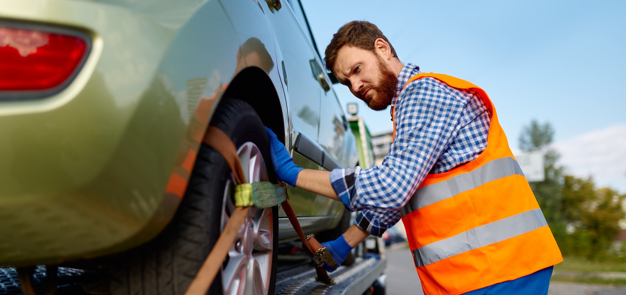 tow-truck-operator-fixing-car-on-platform.jpg