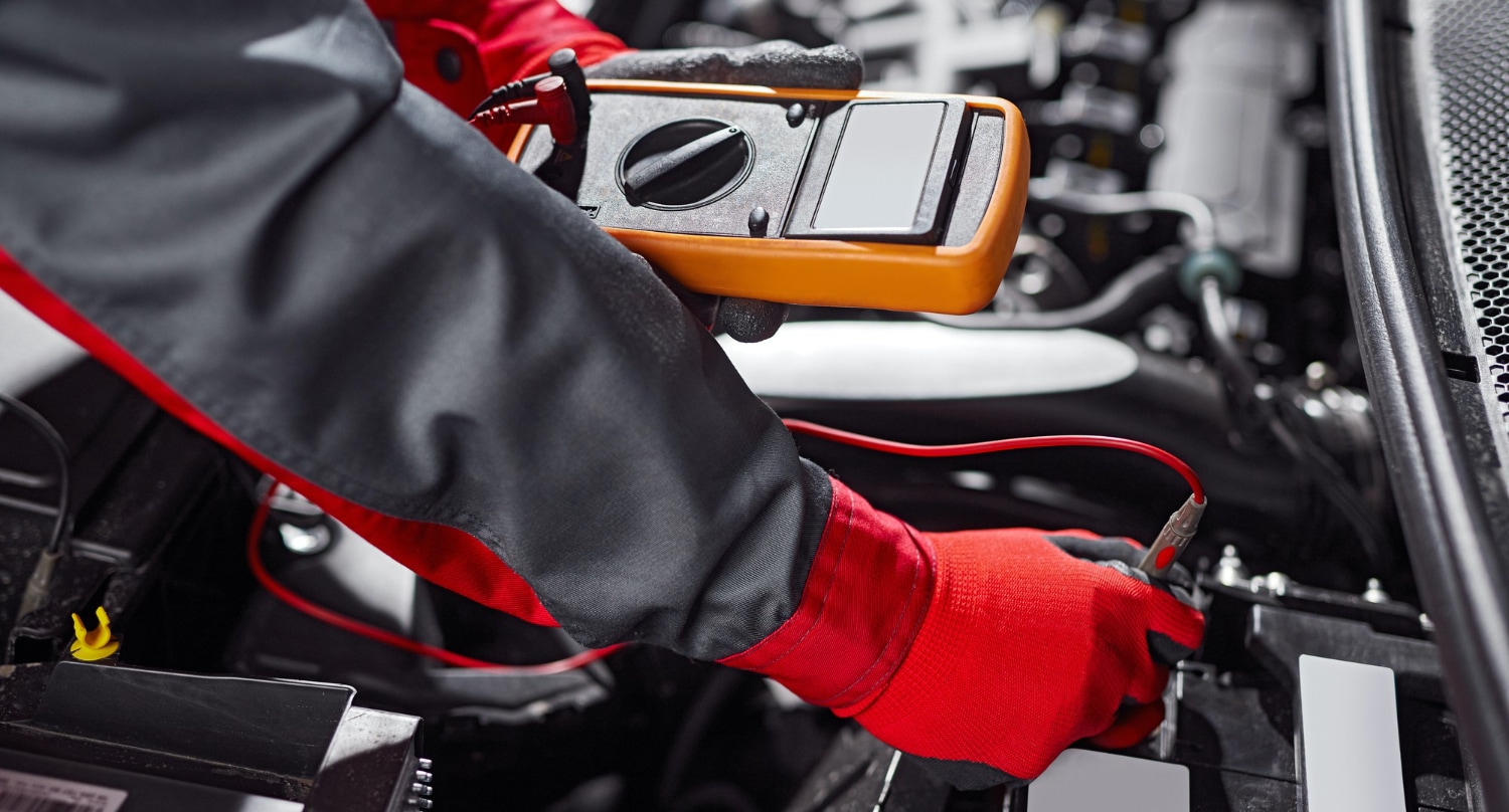 male-mechanic-tester-while-diagnostic-vehicle-battery.jpg