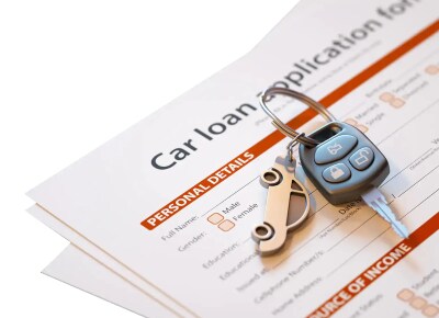 Car Loan Application With Car Keys Laying On It Car Loan Application With Car Keys Laying On It