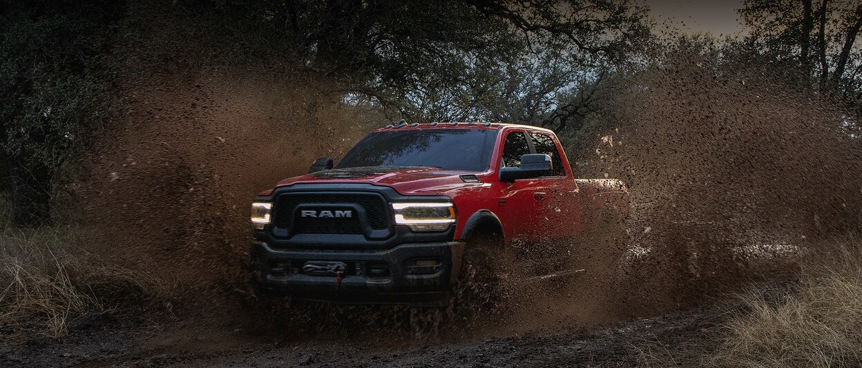 Red 2020 Ram 2500 Driving Off-Road Through Mud Red 2020 Ram 2500 Driving Off-Road Through Mud