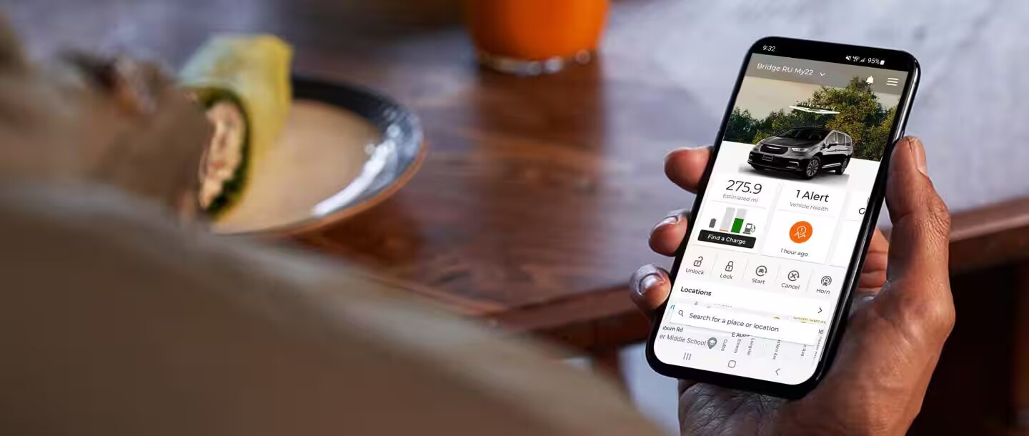 Chrysler vehicle with Uconnect® system An image showcasing the Chrysler Uconnect app