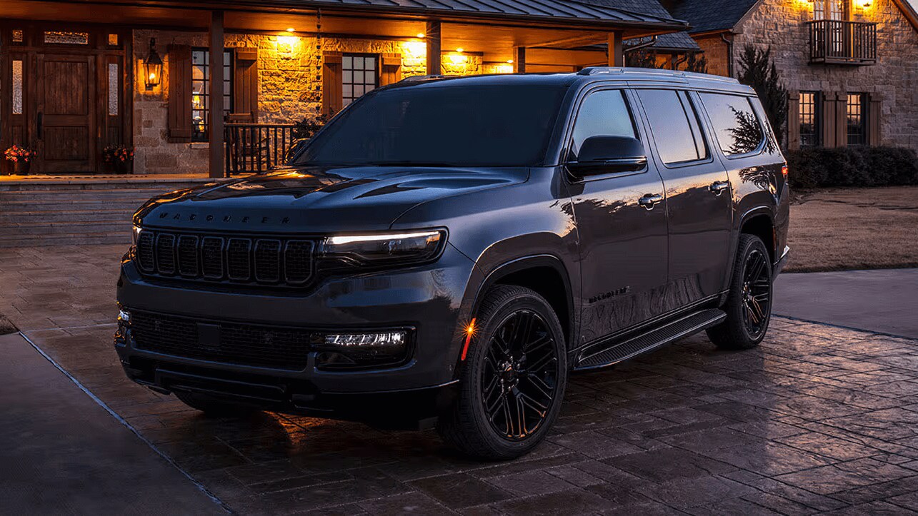 Learn about the 2025 Jeep Wagoneer, available at AutoNation Chrysler Jeep West Black Jeep Wagoneer parked outside a residence