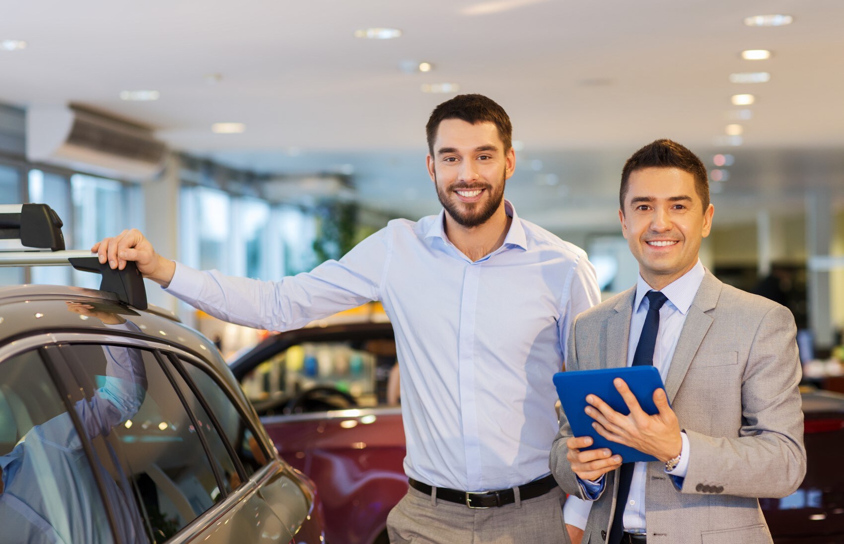 customer and salesman smiling in showroom