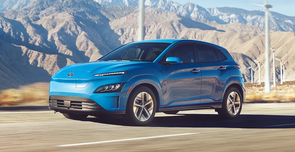 2024-kona-research-center.jpg 2024 Hyundai Kona driving past wind turbines
