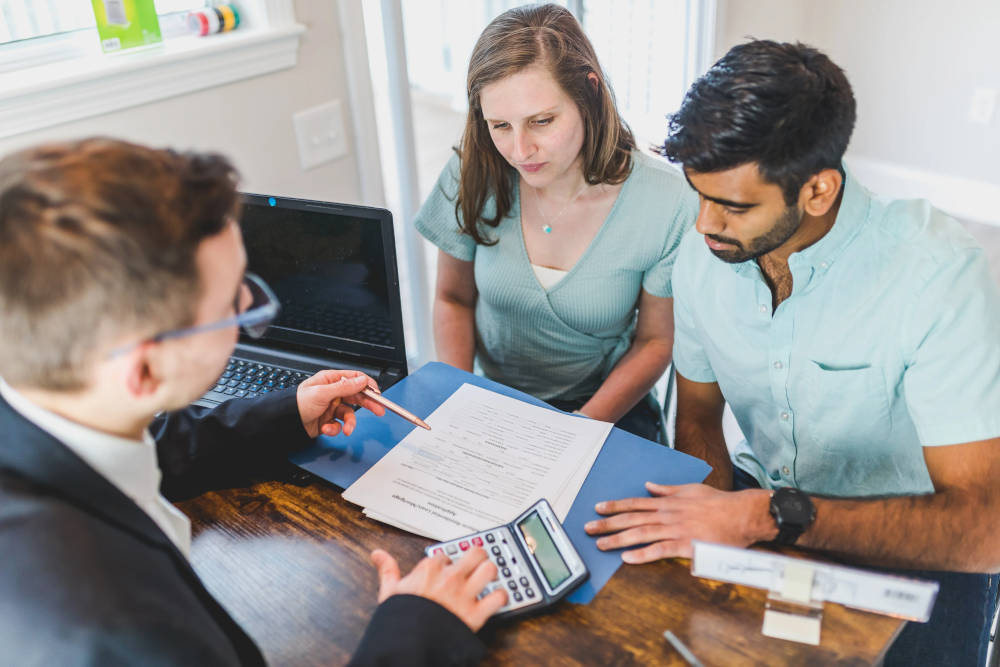 Picture of people reviewing credit papers with a loan officer