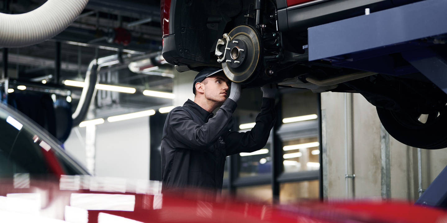 Mazda mechanic servicing a wheel