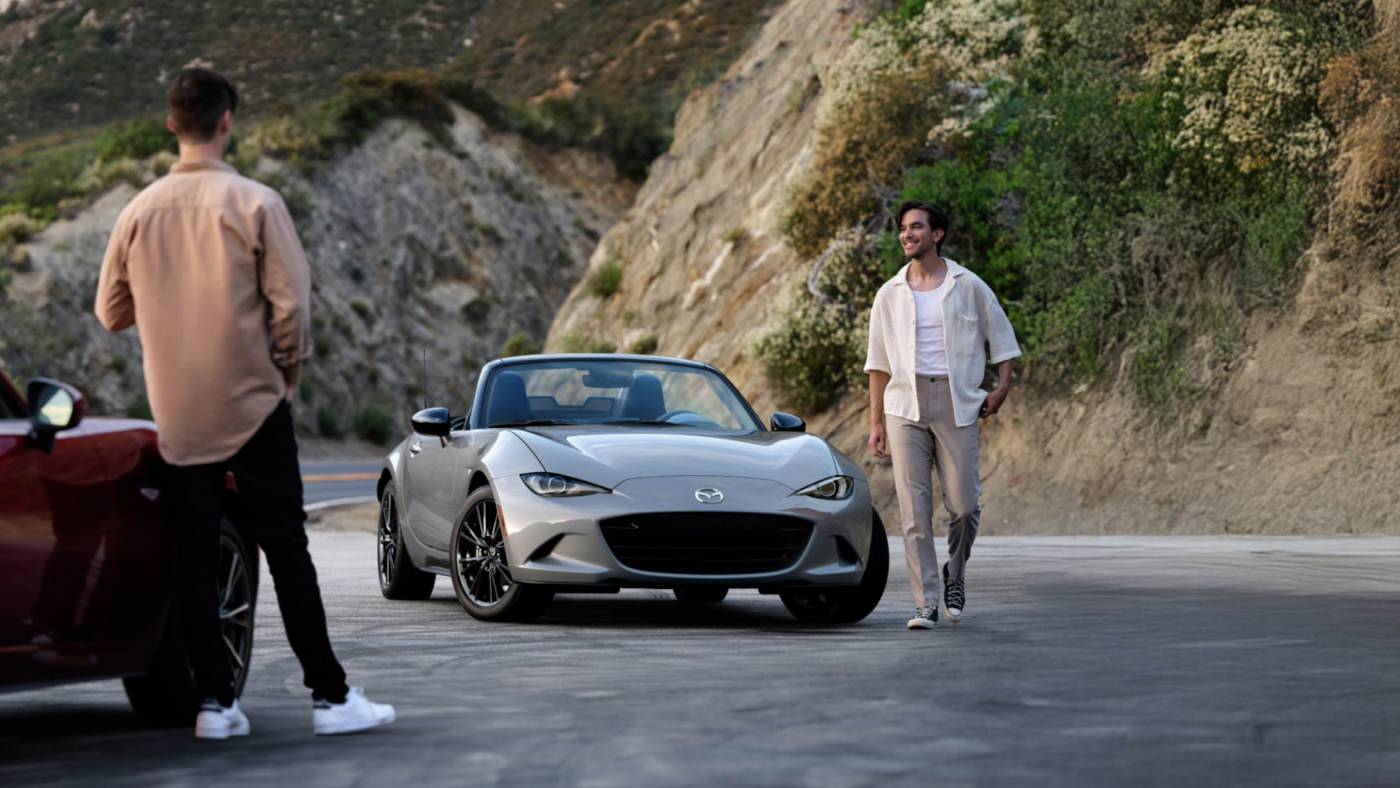 2025 Mazda MX-5 Miata parked with a man walking away from it