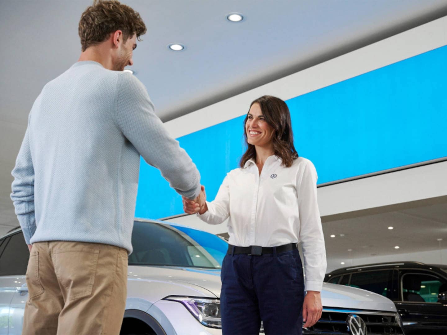 Volkswagen Sales Women shakes hands with a customer