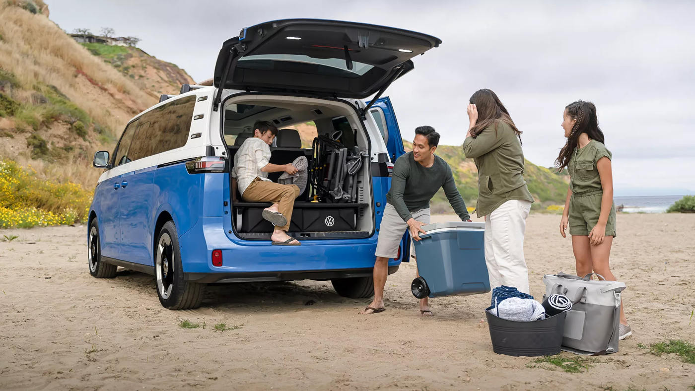 2025 Volkswagen ID Buzz with hatchback open and kids playing in the trunk
