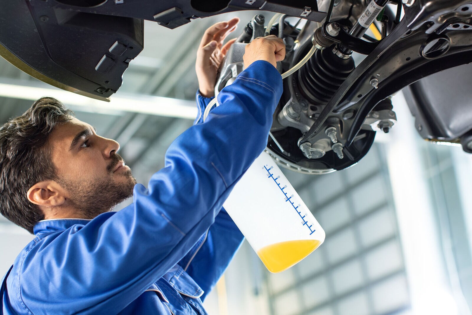 Volkswagen mechanic changing brake fluid