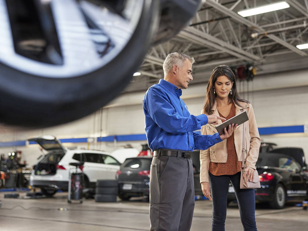 VW Service Technician with a clipboard