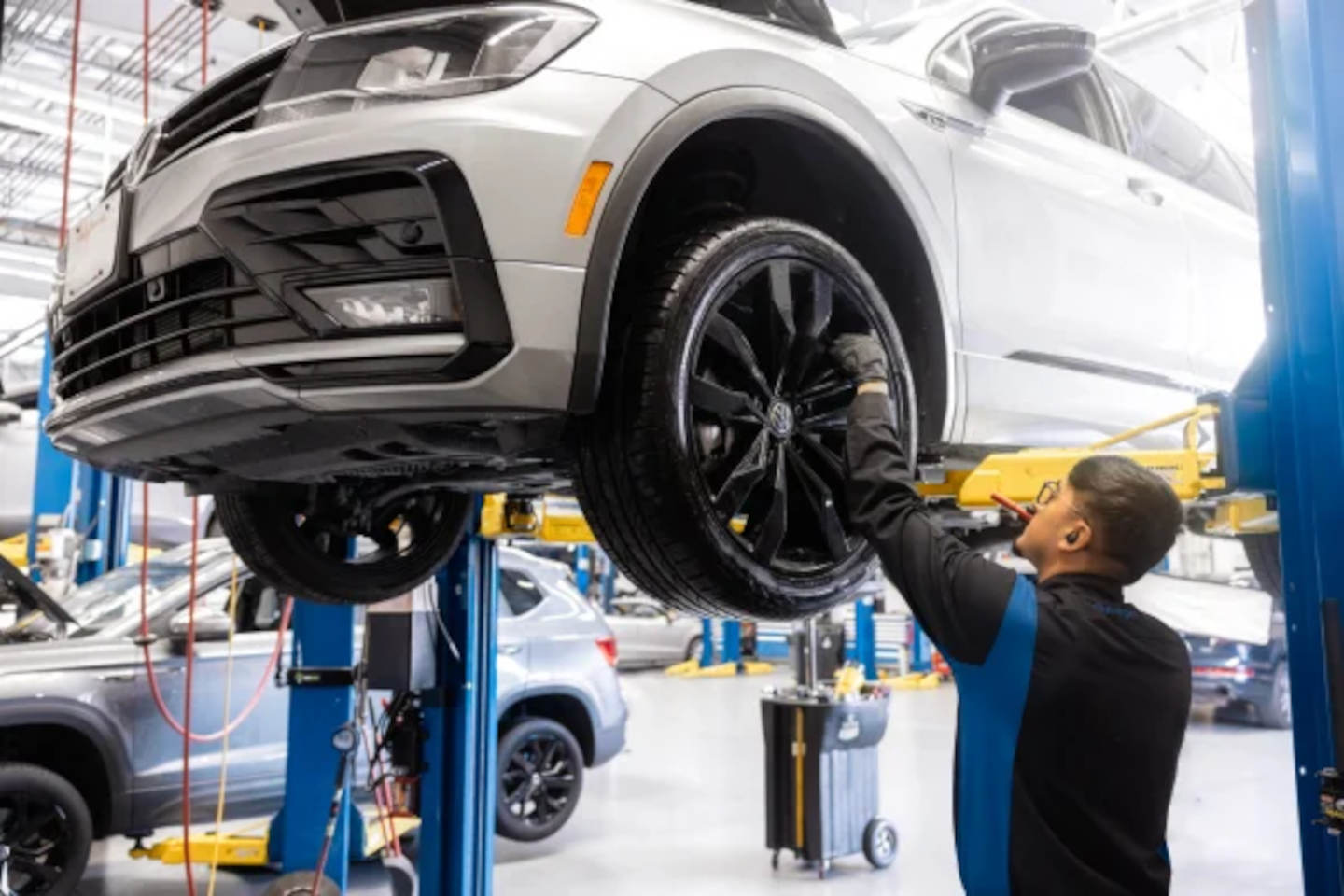 Mechanic servicing a Volkswagen Tiguan