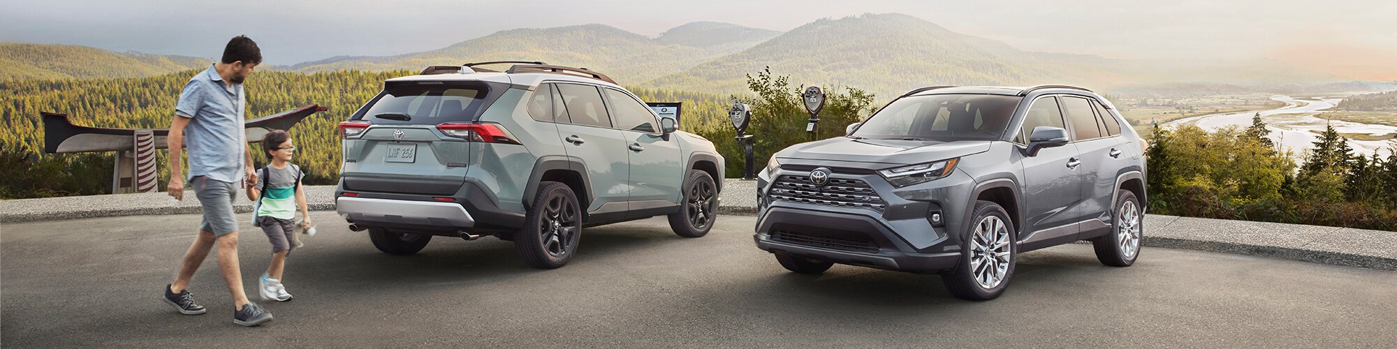 New-2023-Toyota-RAV4-Philadelphia-PA.jpg Father and son looking at two New Toyota RAV4 SUVs.