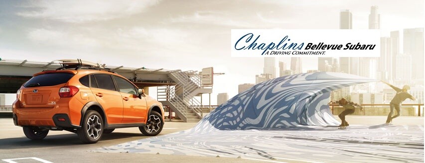 Orange Crosstrek and skateboarders A Driving Commitment logo.jpg