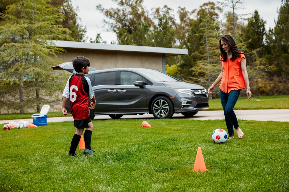 Honda-Lifestyle Mother and son kicking soccer ball with Honda in background.jpeg