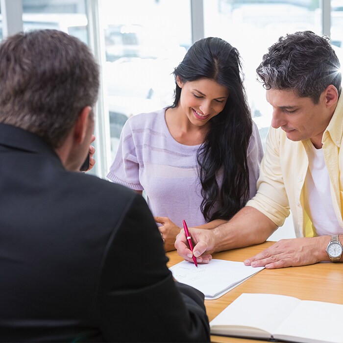 man and woman signing a car loan auto financing or lease credit application.jpg