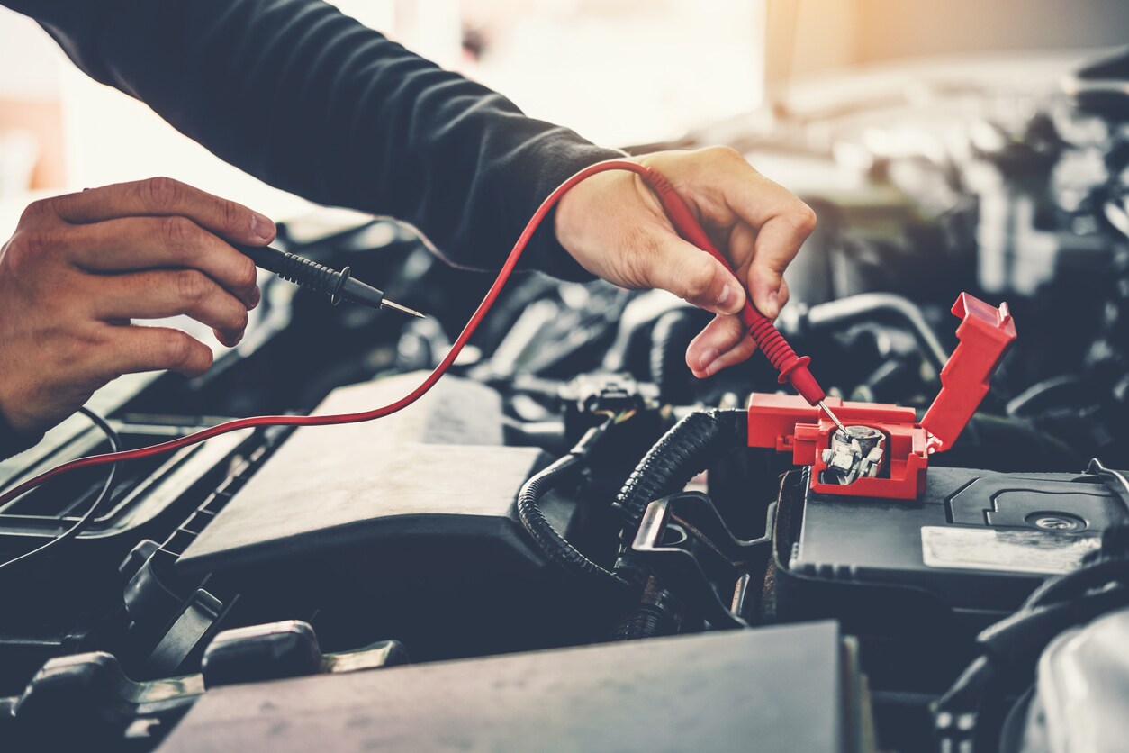 Mechanic checking car battery