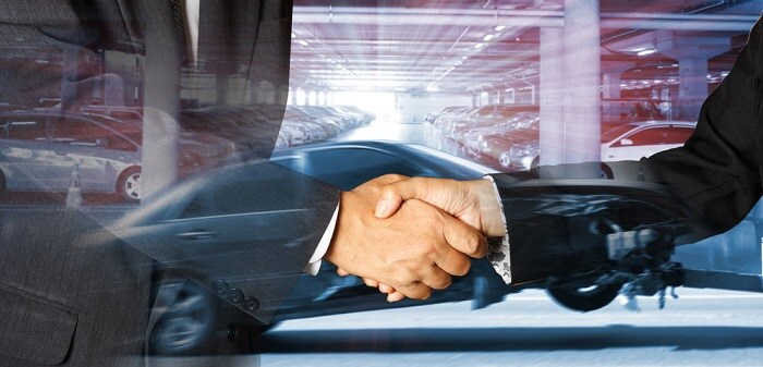 Shaking_Hands_In_Front_Of_Car_Showroom.jpg