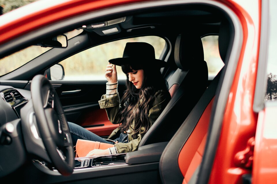 Woman with hat sitting in Jaguar passenger seat.jpeg