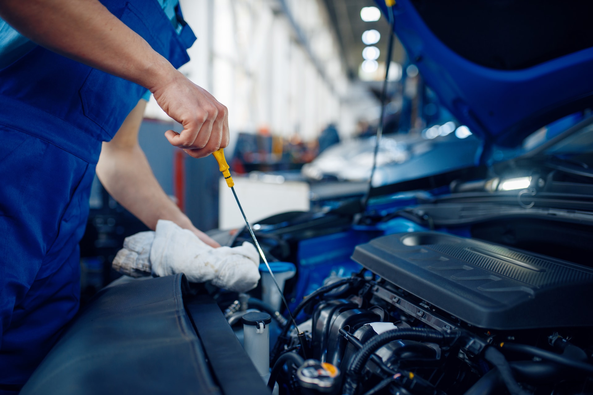 How to Check Your Oil at Chevrolet of New Bern | Mechanic checking oil level in vehicle