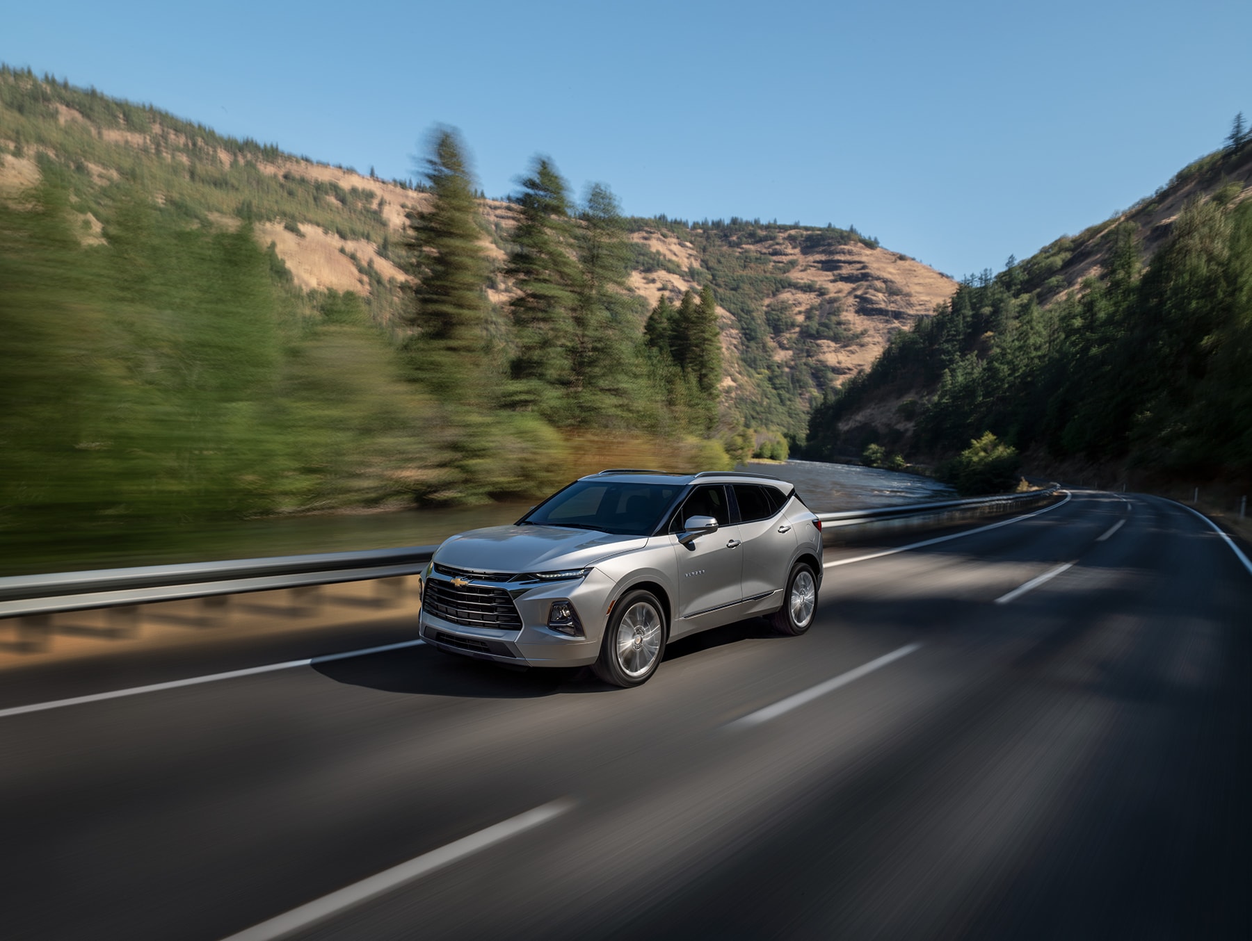 Chevrolet of New Bern is a Car Dealership in New Bern near Pollocksville NC | Silver 2020 Chevrolet Blazer driving on mountain road