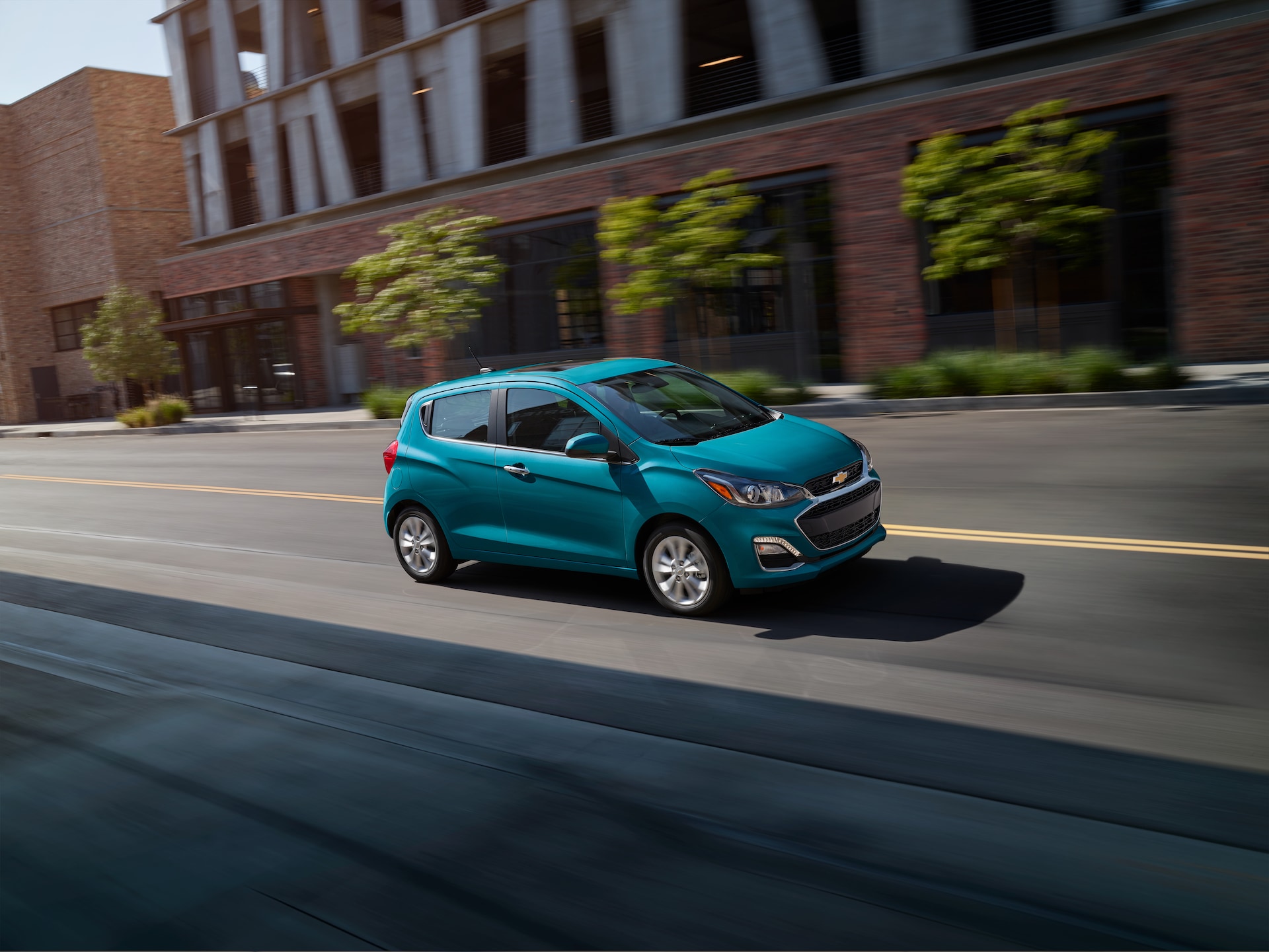 3 Main Benefits of Using OEM parts for your vehicle at Chevrolet of New Bern | Blue 2020 Chevrolet Spark driving downtown