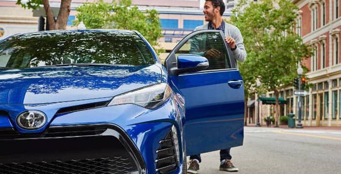 man steps out of 2019 Toyota Corolla