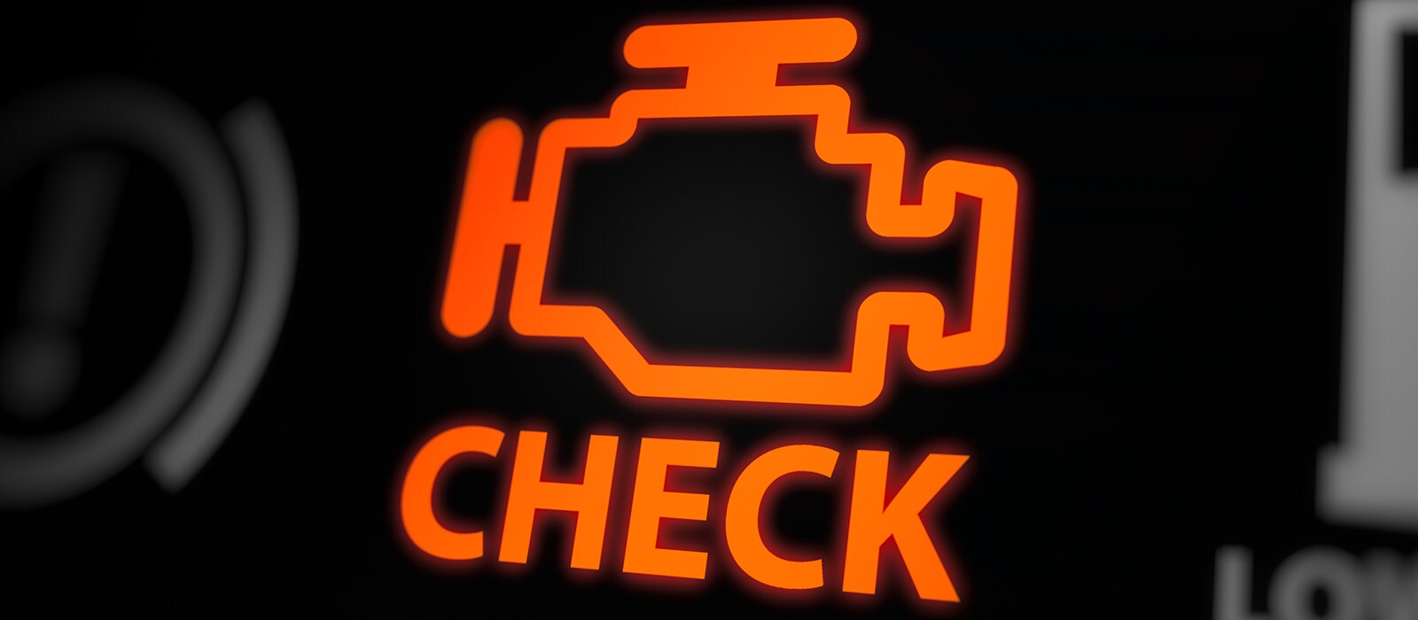 Engine Diagnostics Close up of an orange check engine dashboard light