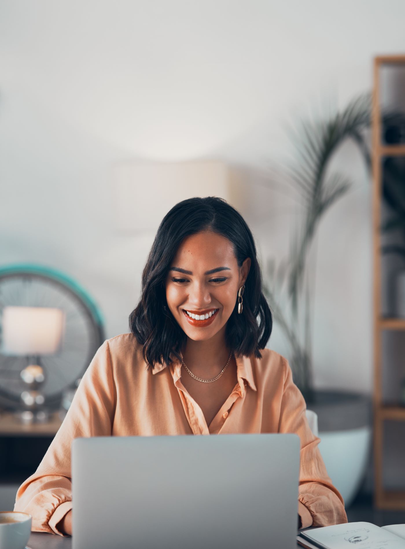 woman smiing at laptop screen