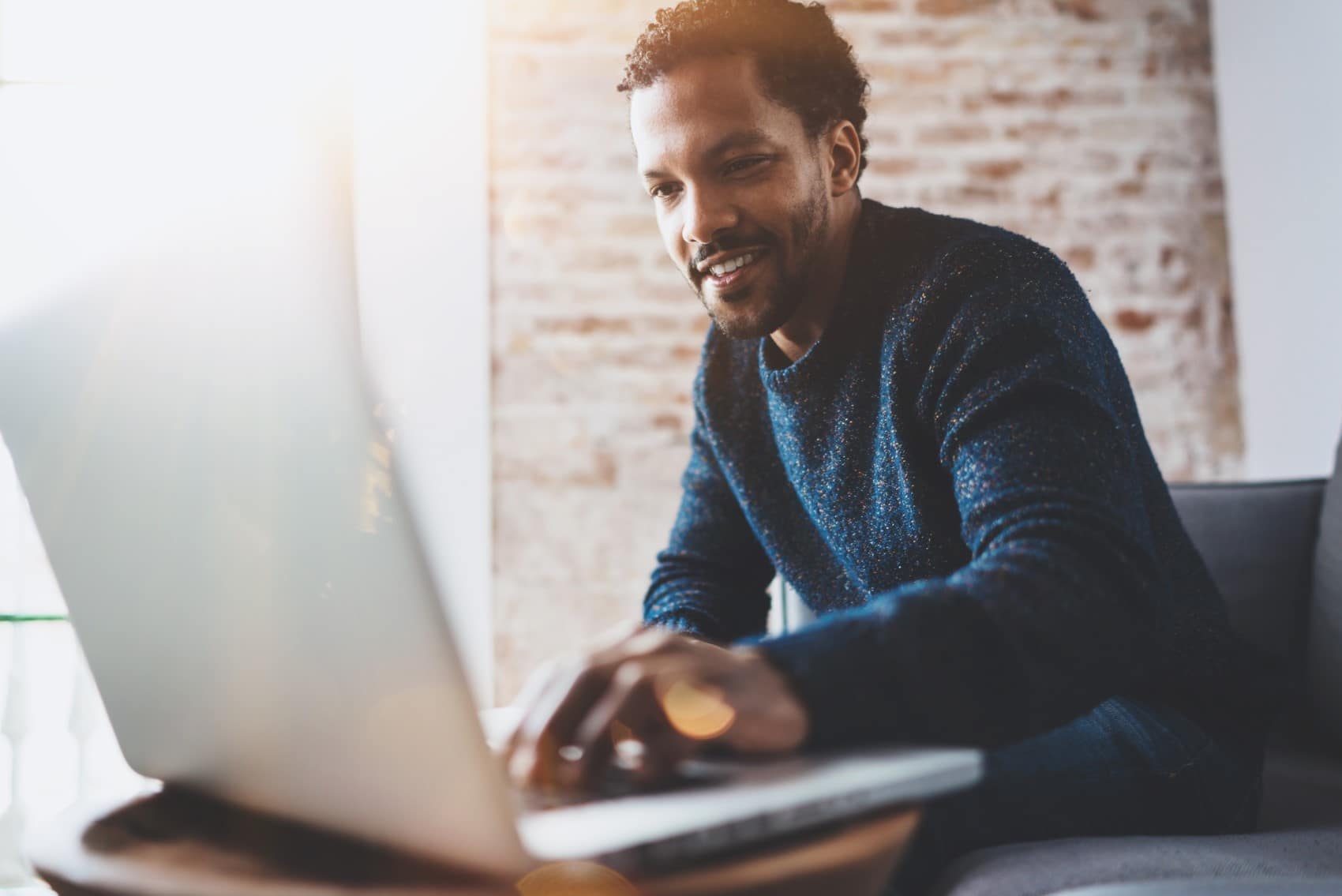 Man scrolling on laptop