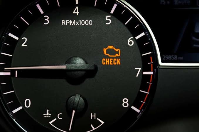 Check engine warning light illuminated on a vehicle dashboard