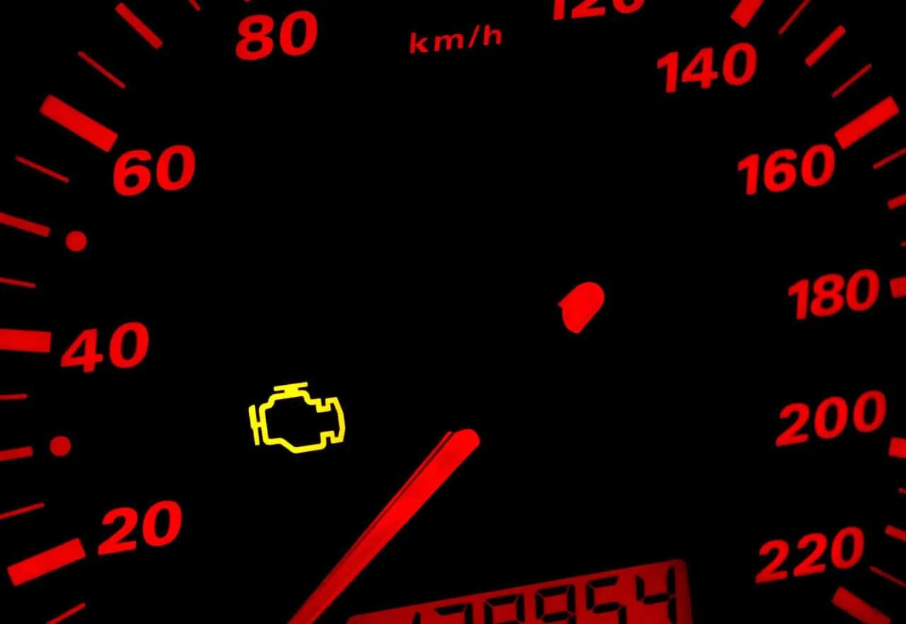 Technician diagnosing a check engine light with vehicle scan equipment