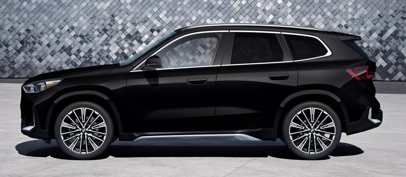 2026 BMW X1 Trim Comparison Black 2026 BMW X1 parked in front of a wall