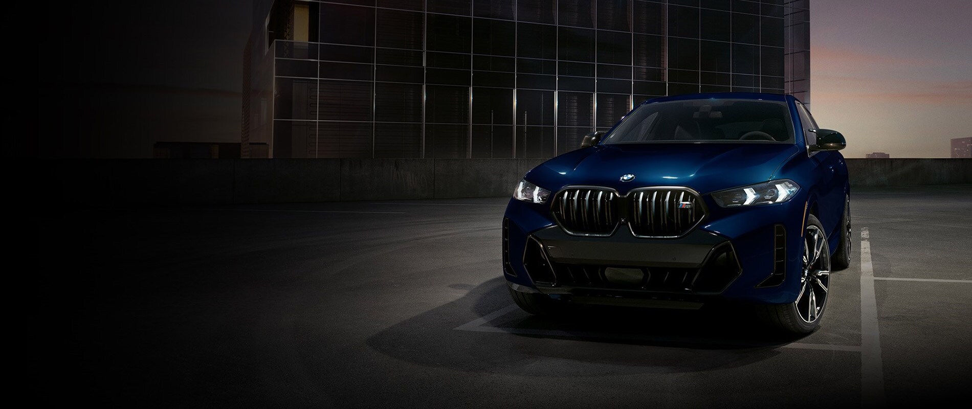 2026 BMW X6 Trim Comparison 2026 BMW X6 parked in a parking lot at dusk
